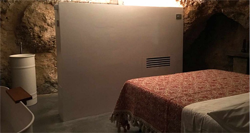 Piccolo fabbricato con una grotta scavata in roccia a Calascio (AQ) Camera con servizi realizzati nella grotta Progetto di recupero della OrianoAssociati Engineering